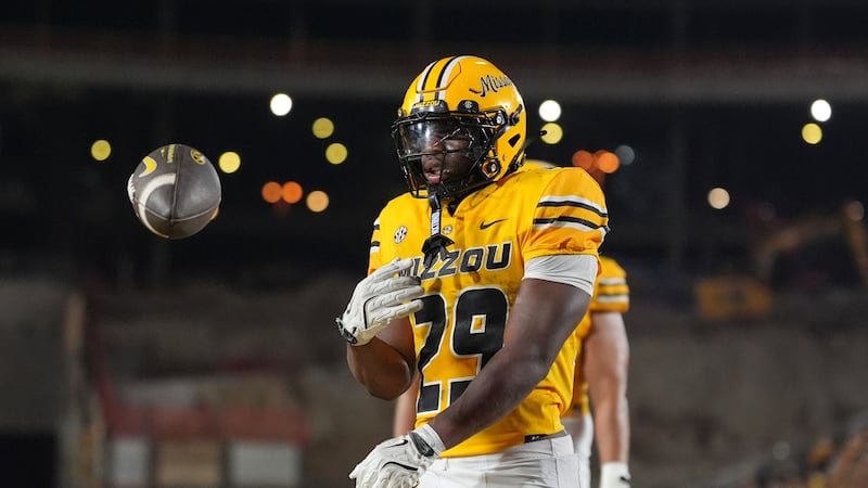Missouri running back Ahmad Hardy celebrates after scoring during the first half of an NCAA...