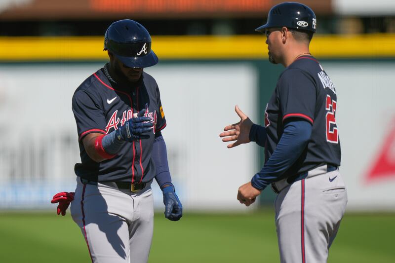 Atlanta Braves right fielder Bryan De La Cruz (14) celebrates an RBI single during the fifth inning of a spring training baseball game against the Pittsburgh Pirates, Tuesday, Feb. 25, 2025, in Bradenton, Fla. (AP Photo/Stephanie Scarbrough)