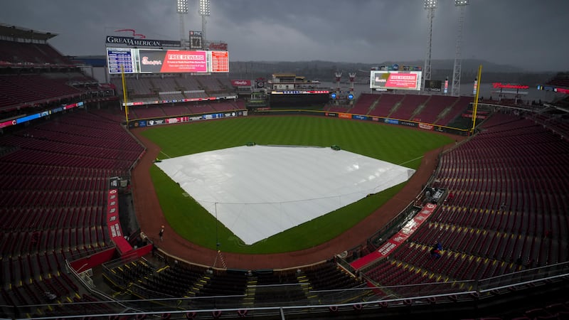 A view of the tarp on the field as rain falls before a baseball game against the Milwaukee...