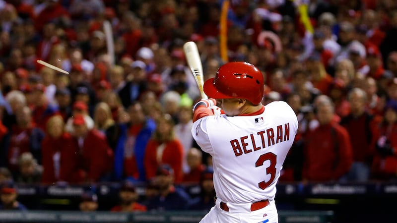 St. Louis Cardinals right fielder Carlos Beltran splinters his bat as hits an RBI single...