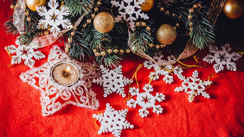Christmas card with fir tree branch decorated with golden baubles, garlands and vintage...