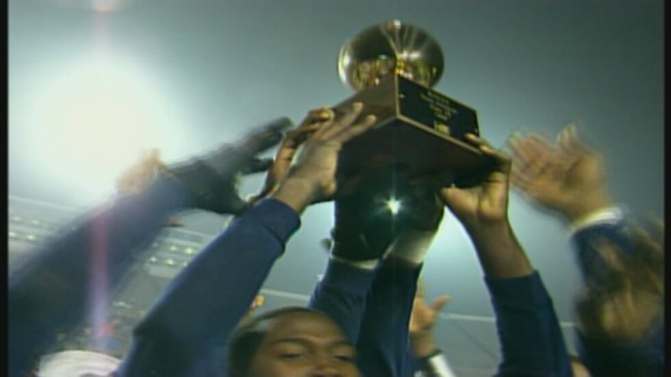 The Moss Point Tigers hold up a MHSAA State Championship trophy following one of their five...