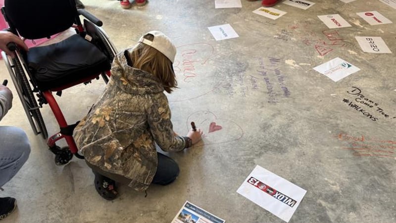 St. Jude patient Jace Matthews signs the 2026 St. Jude Dream Home floor.