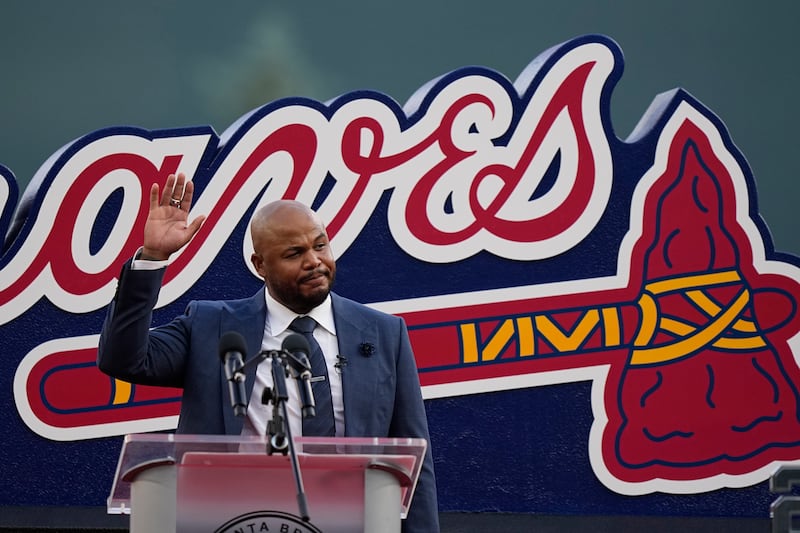 Former Atlanta Braves player, Andruw Jones waves to the crowd as he is honored, Saturday, Sept. 9, 2023, in Atlanta. Jones who won 10 Gold Gloves in a career that began with 12 seasons in Atlanta, became the 11th Braves player or manager to have his number retired on Saturday night. The honor could add momentum to his candidacy for the Baseball Hall of Fame. Jones' 25 was retired before the Braves' game against the Pittsburgh Pirates. (AP Photo/Brynn Anderson)