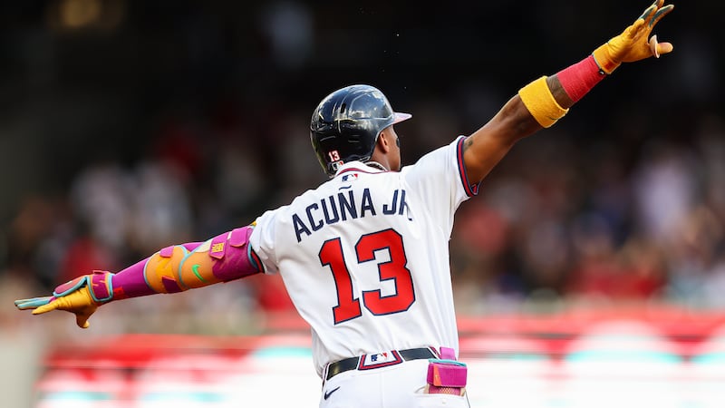 Atlanta Braves' Ronald Acuña Jr. reacts after hitting a two-run home run in the first inning...