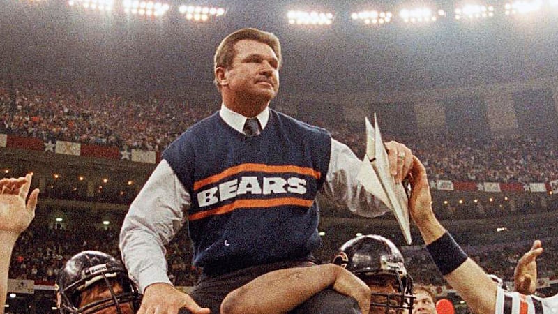 FILE - In this Jan. 26, 1986, file photo, Chicago Bears coach Mike Ditka is carried off the field by Steve McMichael, left, and William Perry after the Bears defeated the New England Patriots 46-10 in NFL football's Super Bowl XX in New Orleans. Willie Gault (83) and Maury Buford (8) join the celebration.