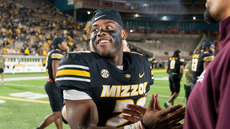 Missouri running back Ahmad Hardy, left, is congratulated after his team defeated Mississippi...