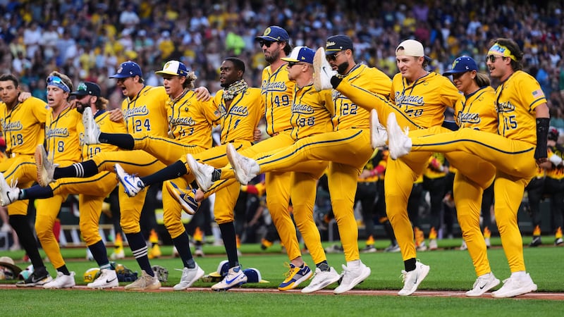 FILE - The Savannah Bananas do a kick line before their game against the Firefighters during...