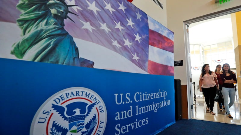 FILE - In this Aug. 17, 2018, file photo, people arrive before the start of a naturalization...