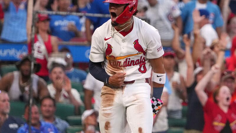 St. Louis Cardinals' Masyn Winn celebrates after scoring from second on a sacrifice fly by...