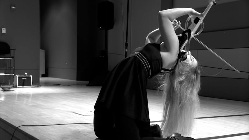 Michelle Winters displays impressive core strength while playing the violin during Look Up...