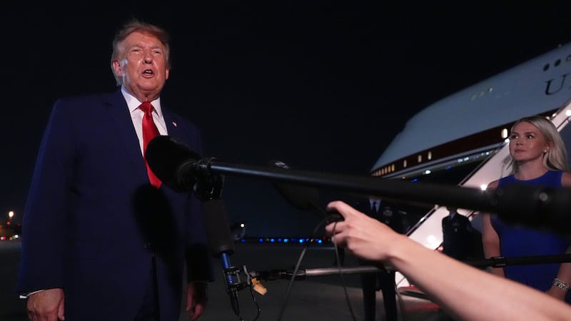 El presidente Donald Trump habla con reporteros después de llegar a bordo del Air Force One,...
