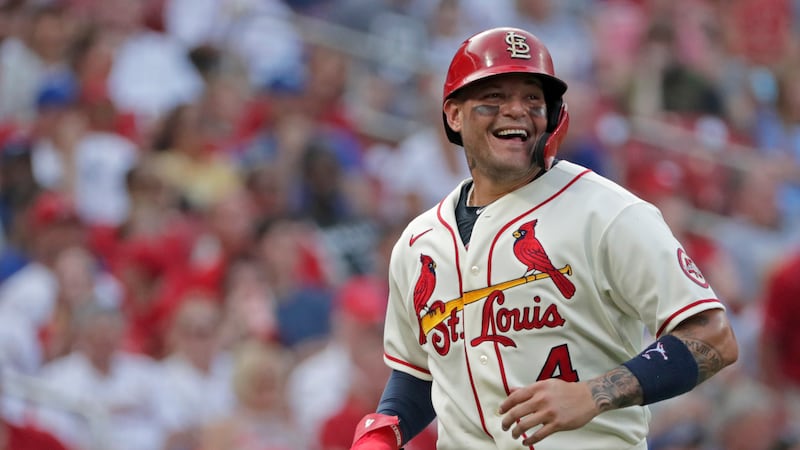 St. Louis Cardinals catcher Yadier Molina smiles while looking toward Kansas City Royals...