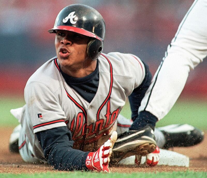 Atlanta Braves Andruw Jones slides safely into third base in the fourth inning against the Milwaukee Brewers in this  June 3, 1998 file photo, in Milwaukee.  The Atlanta Braves are cutting ties with Jones, saying they can't afford to keep the perennial Gold Glove center fielder who's spent his entire career with the organization. (AP Photo/Gary Dineen,file)