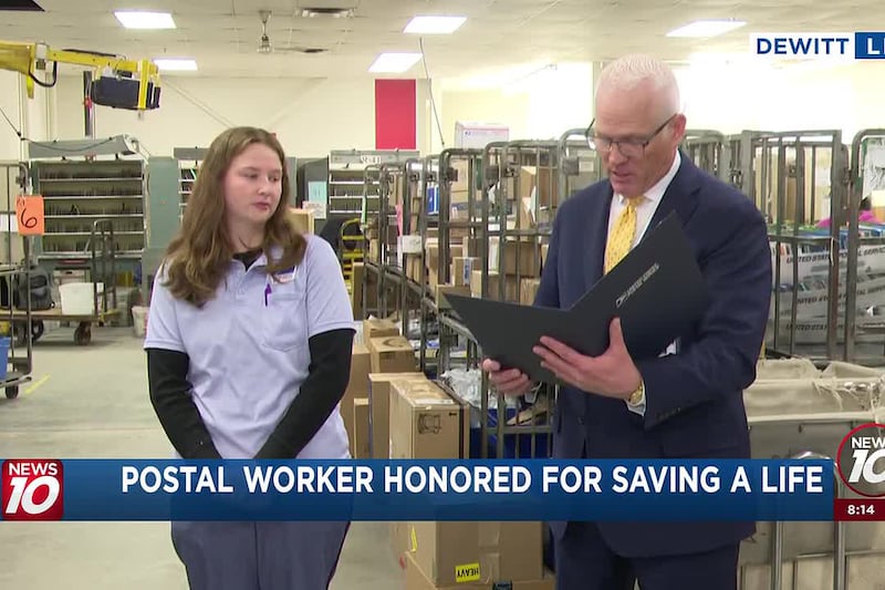 Postal worker honored for saving woman's life